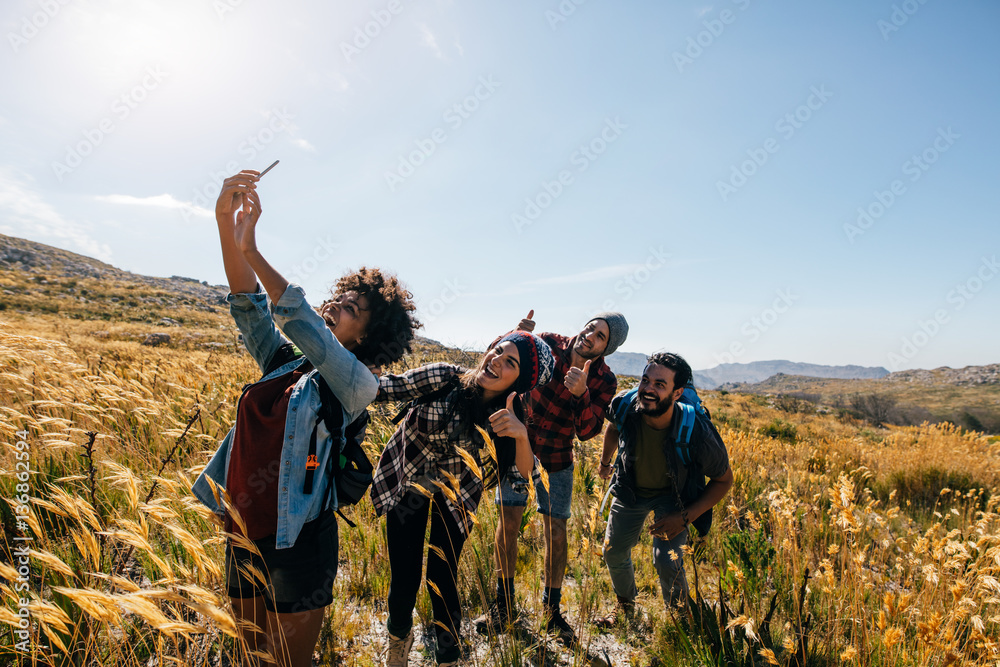 Friends taking selfie on countryside hike