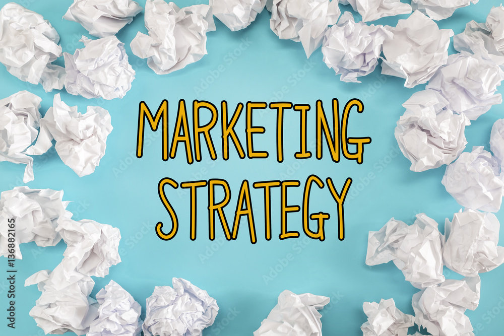 Marketing Strategy text with crumpled paper balls