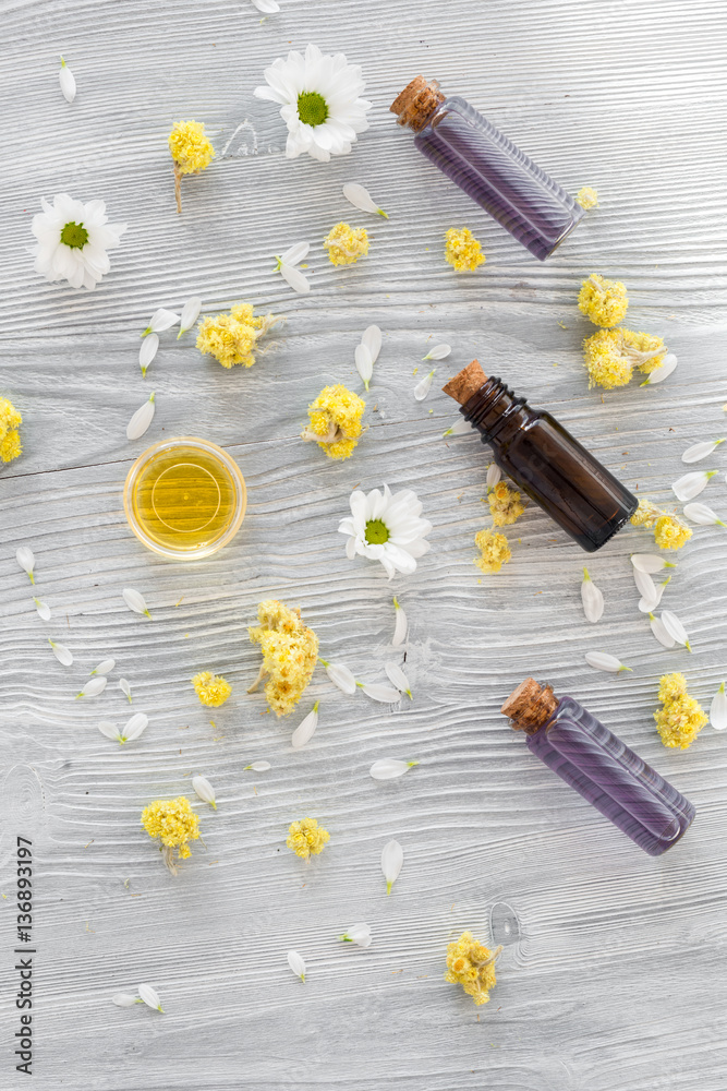 organic cosmetics with camomile on wooden background top view