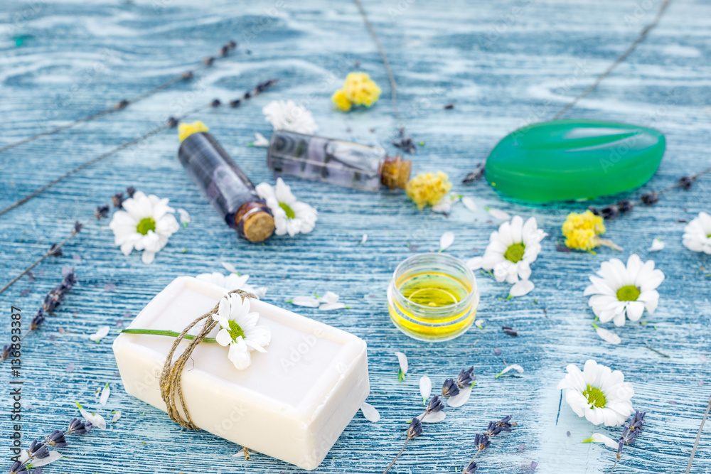 organic cosmetics with camomile on blue background