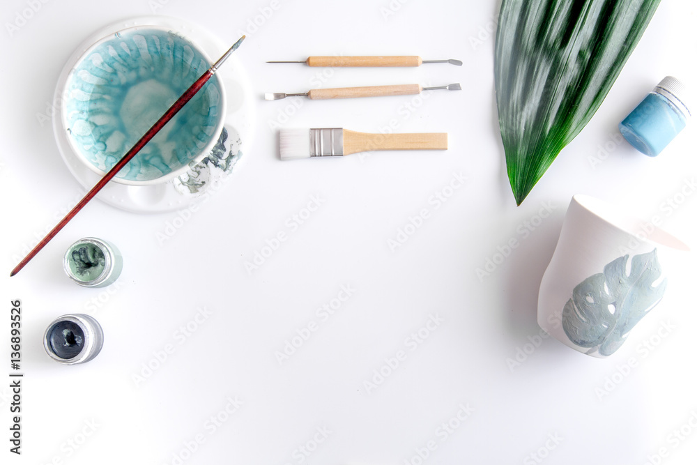 painted ceramic cup on white background top view