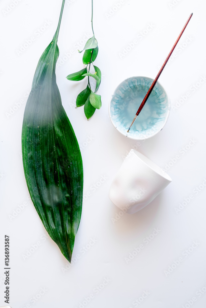 painted ceramic cup on white background top view