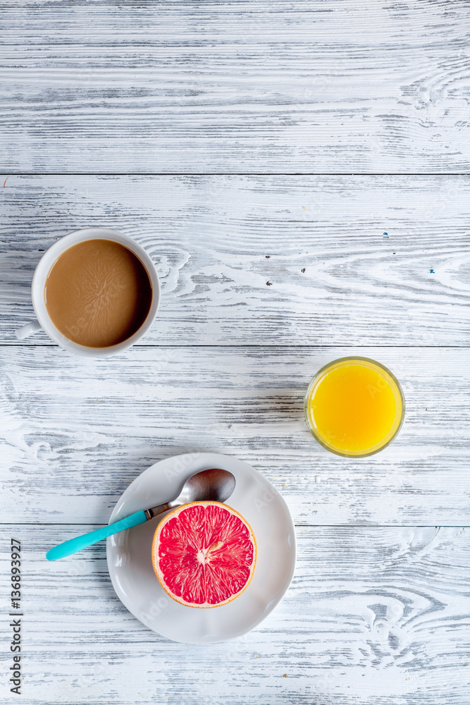 Breakfast concept with flowers on wooden background top view