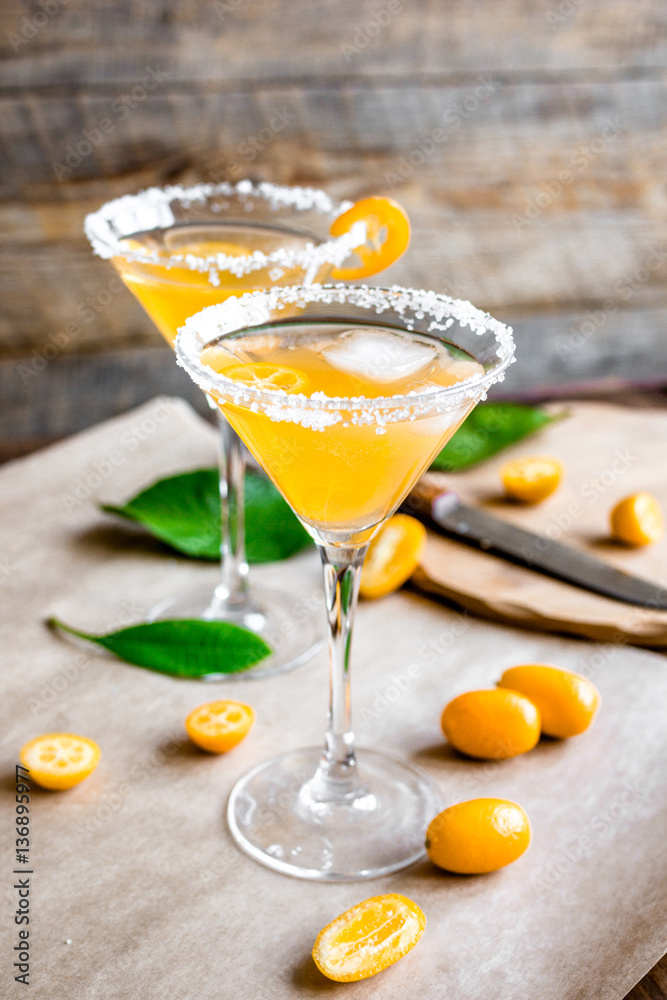 cocktail with kumquat on wooden background