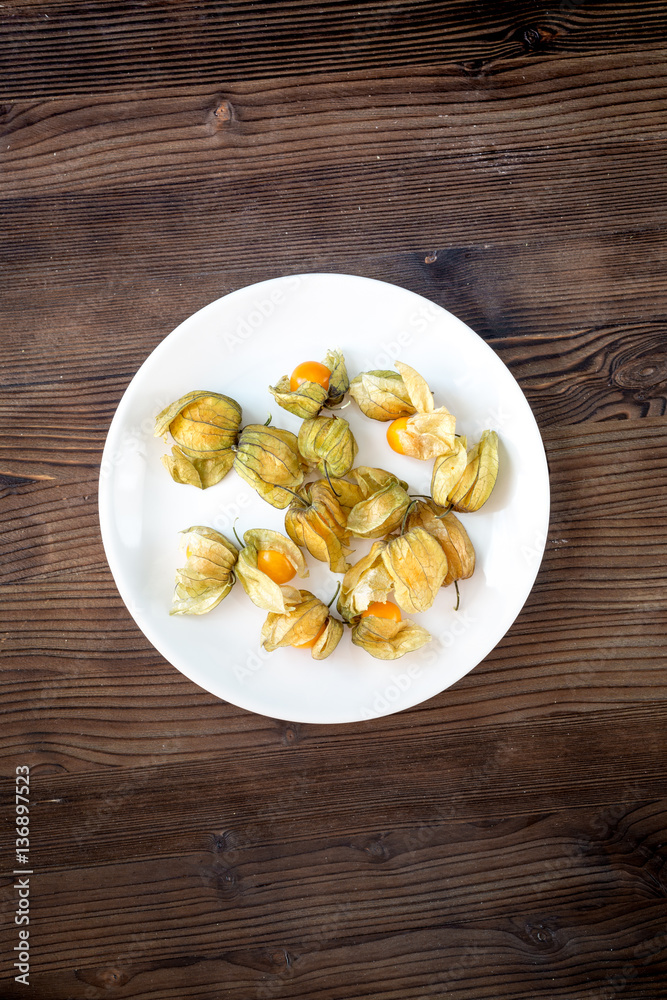 physalis on wooden background top view mock up