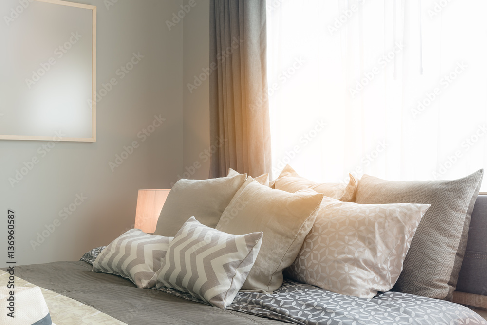 set of pillows on bed in cozy bedroom