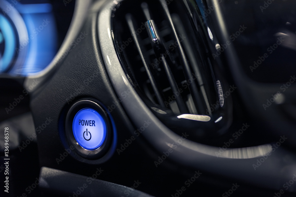 Car dashboard with focus on engine start stop button