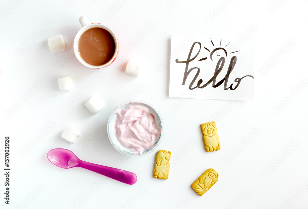 concept kid breakfast with yogurt top view white background