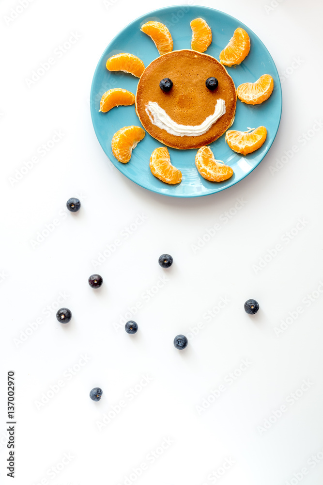 concept kid breakfast with pancake top view on white background