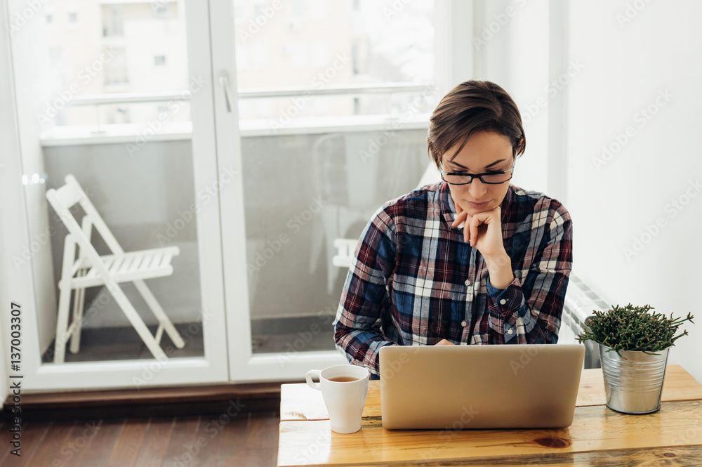 Pensive woman working at home