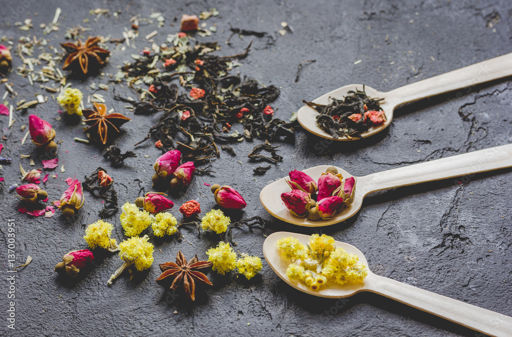 Herbs and spoons on grey background