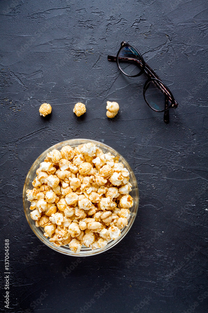 concept of watching movies with popcorn top view dark background