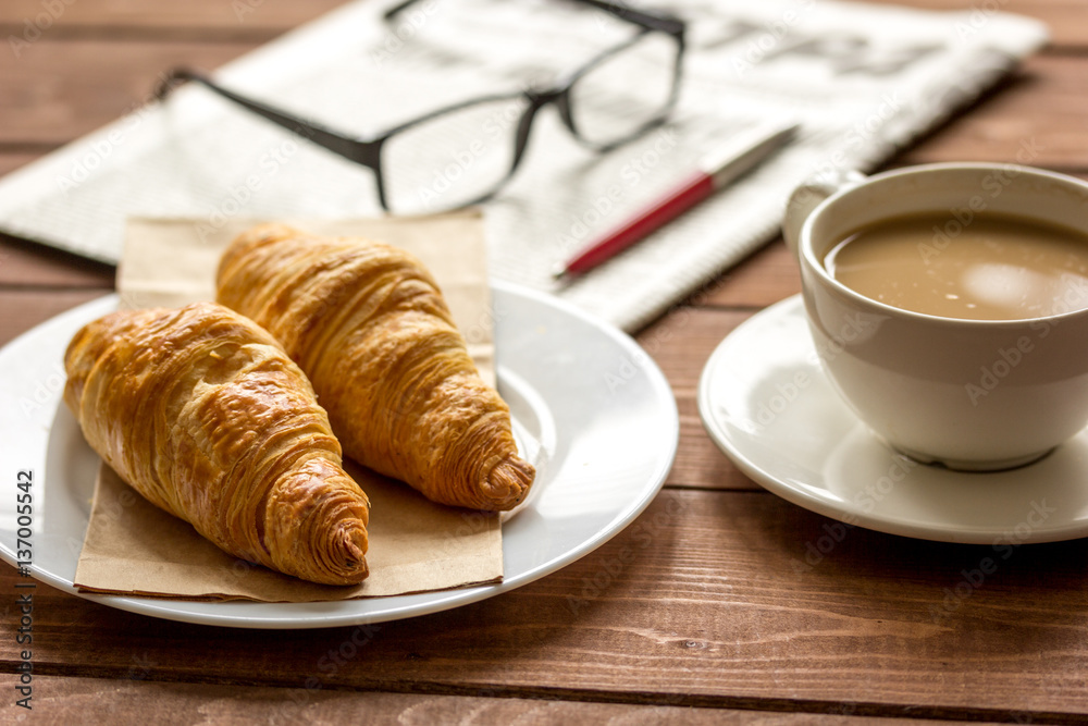 Businessman morning cup of coffee at home with newspaper