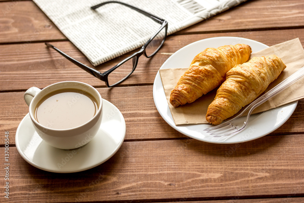 Businessman morning cup of coffee at home with newspaper