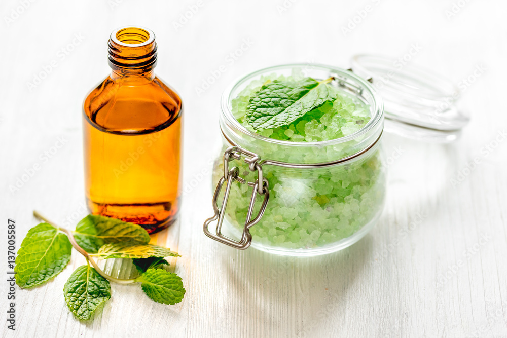 organic cosmetics with herbal extracts of mint on wooden background