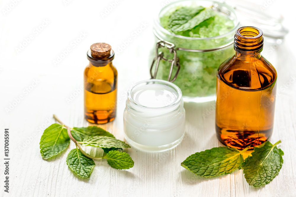 organic cosmetics with herbal extracts of mint on wooden background