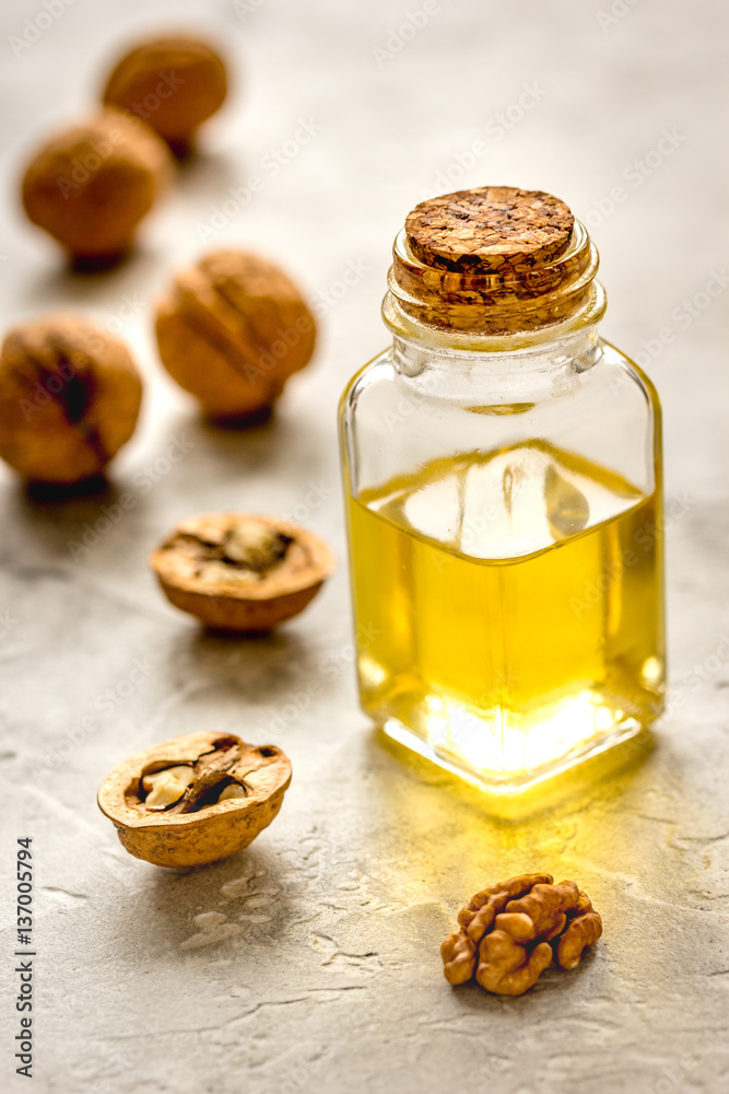 cosmetic and therapeutic walnut oil on gray background