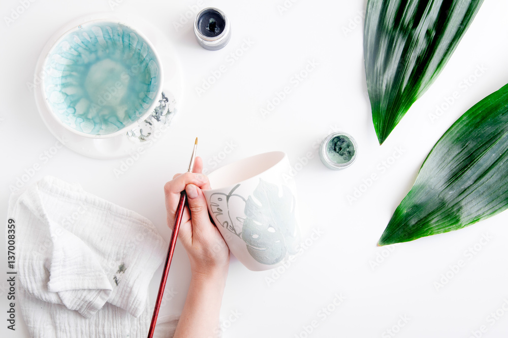 painted ceramic cup on white background top view