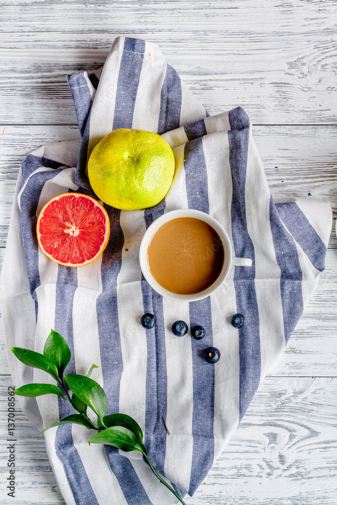 Breakfast concept with flowers on wooden background top view