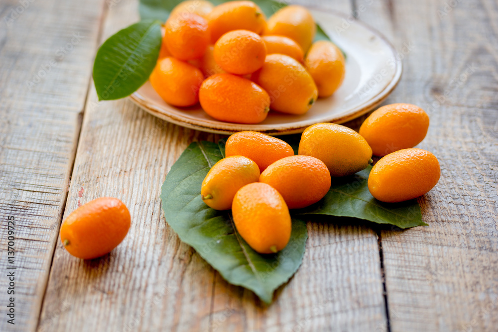 kumquat on plate at wooden table