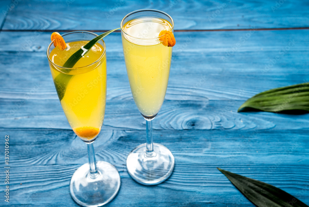 cocktail with physalis in glass on wooden background