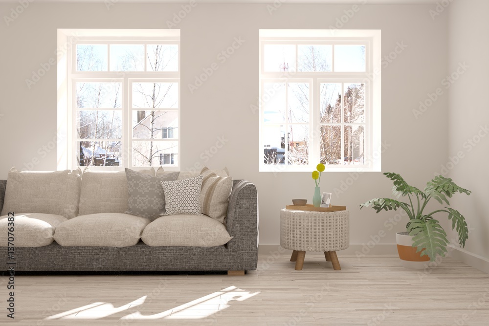 Modern interior design with sofa and winter landscape in window