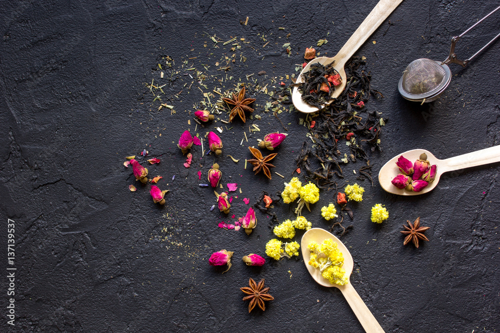 Spoons with herbs on dark background mockup top view