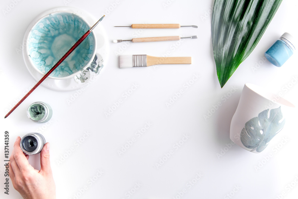 painted ceramic cup on white background top view