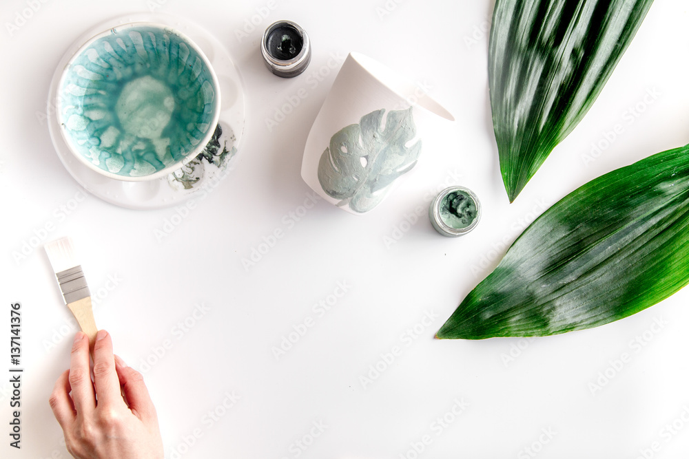 painted ceramic cup on white background top view