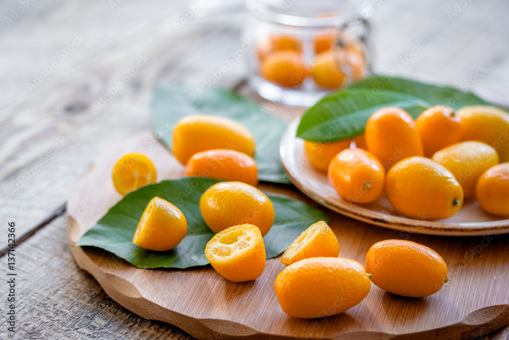 kumquat on plate at wooden table