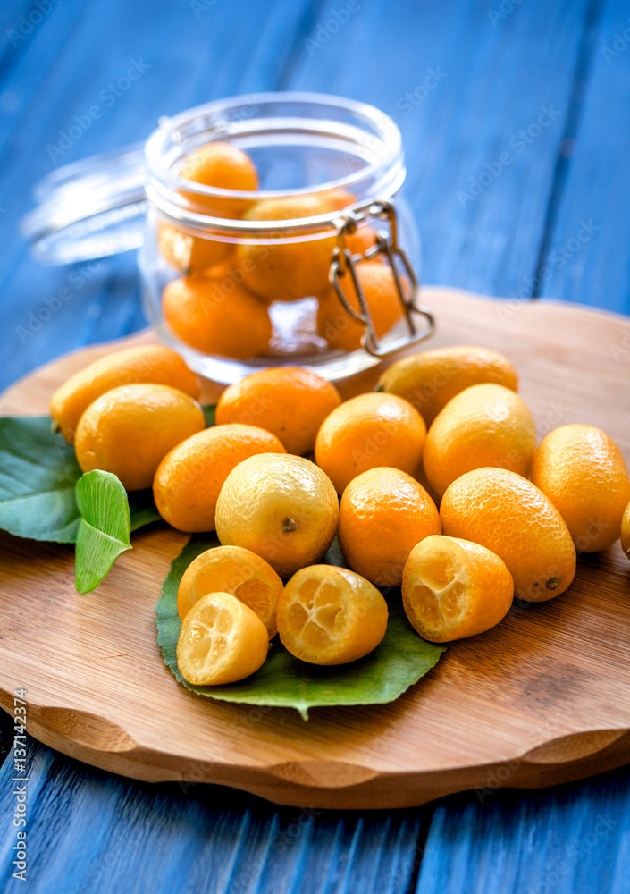 kumquat on plate at wooden table