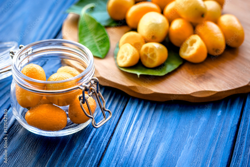 kumquat on plate at wooden table