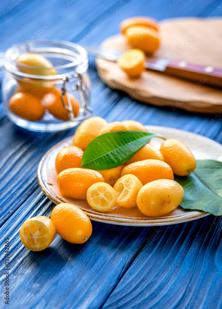 kumquat on plate at wooden table