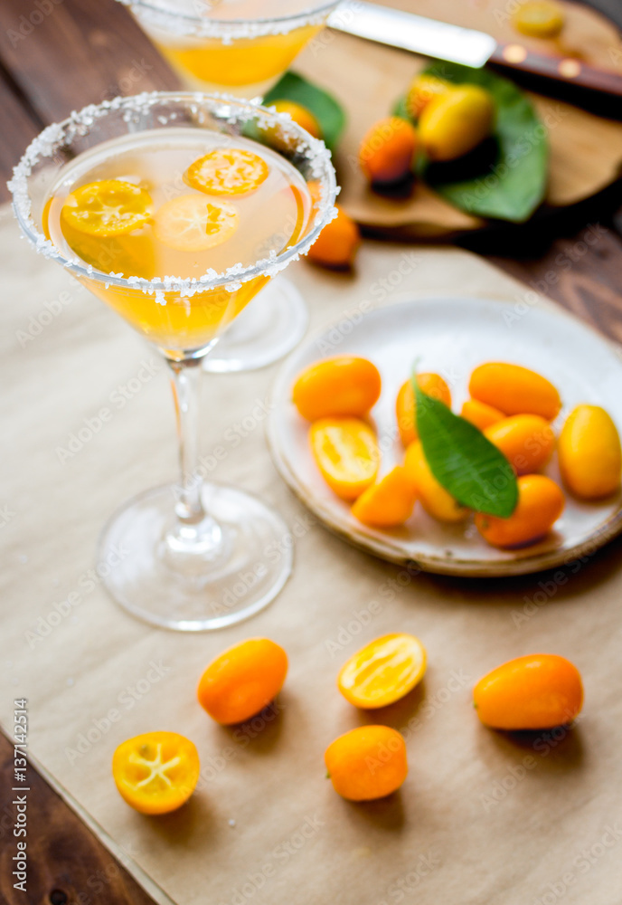 cocktail with kumquat on wooden background