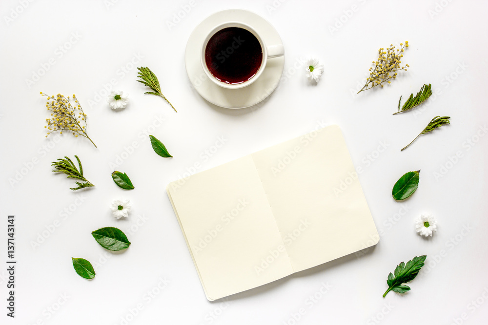 Copybook, americano and flowers on white table top view mock-up