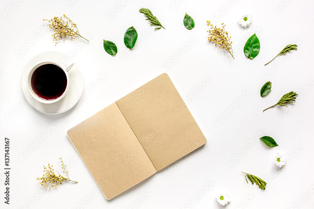 Froral flat lay with cup and notepaper top view mockup