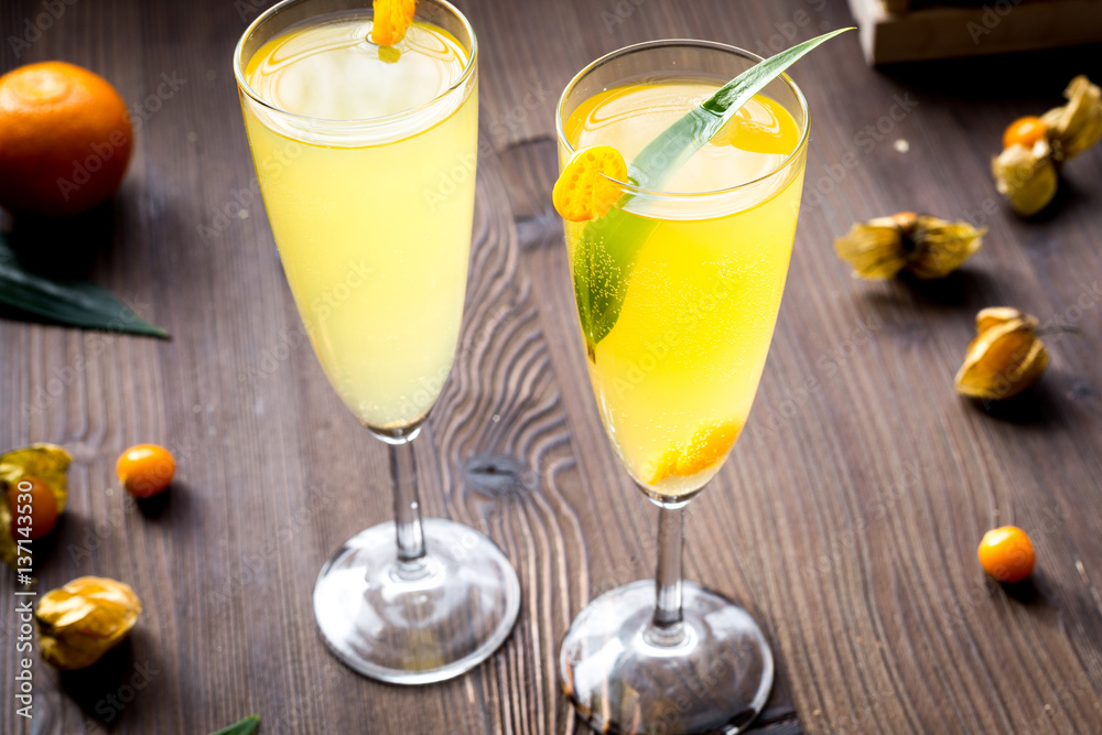 cocktail with physalis in glass on wooden background