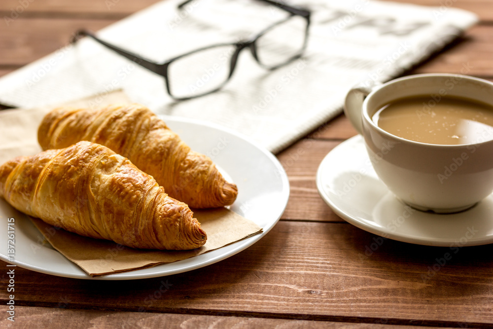 Businessman morning cup of coffee at home with newspaper