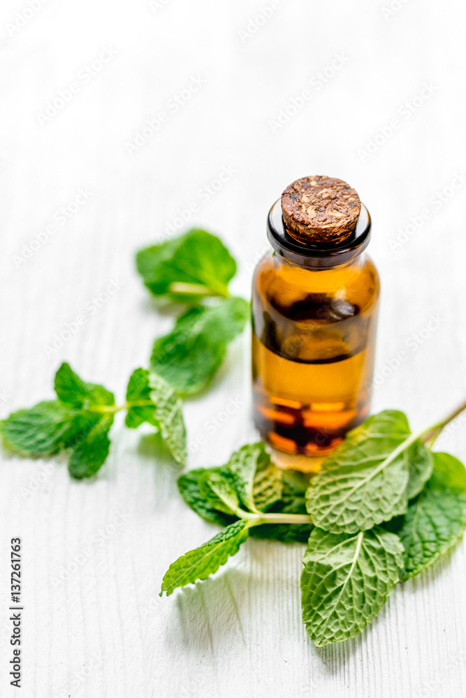 organic cosmetics with herbal extracts of mint on wooden background