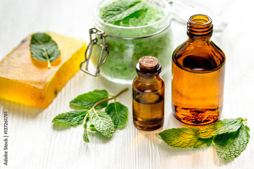 organic cosmetics with herbal extracts of mint on wooden background