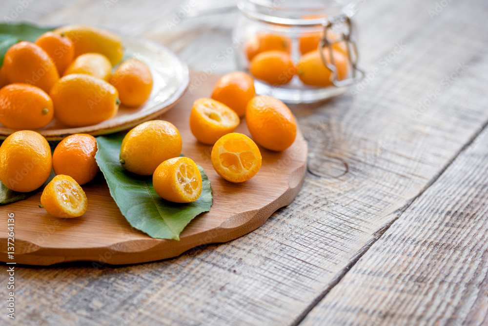 kumquat on plate at wooden table