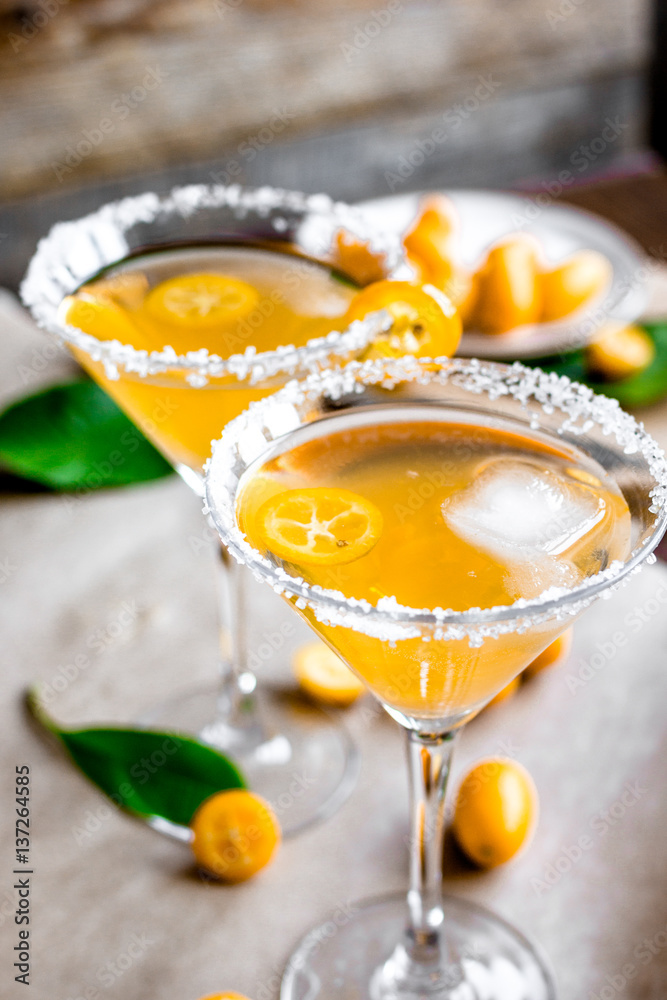 cocktail with kumquat on wooden background