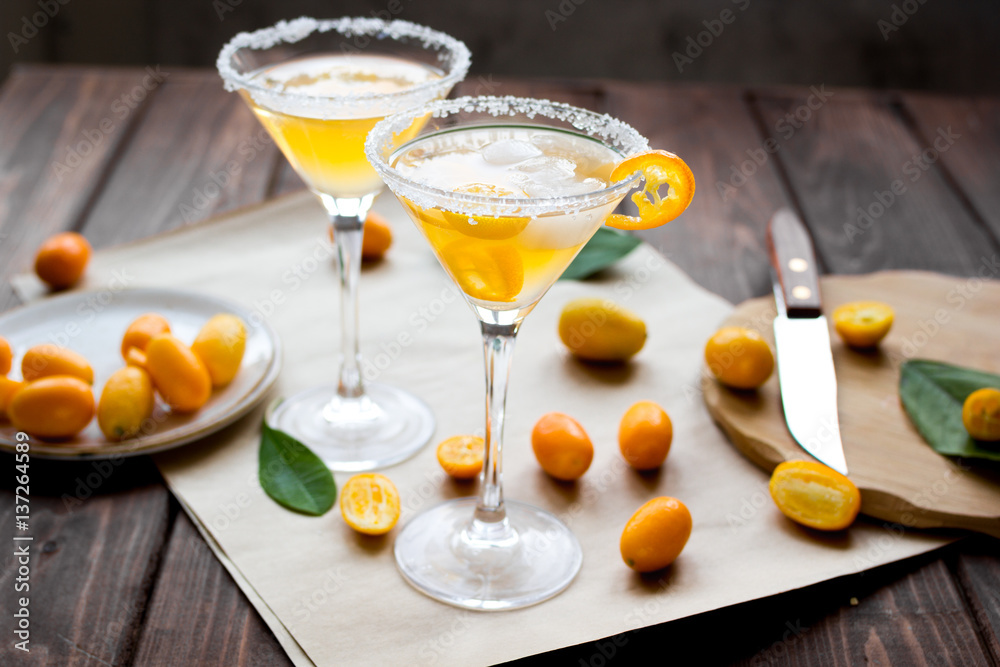 cocktail with kumquat on wooden background