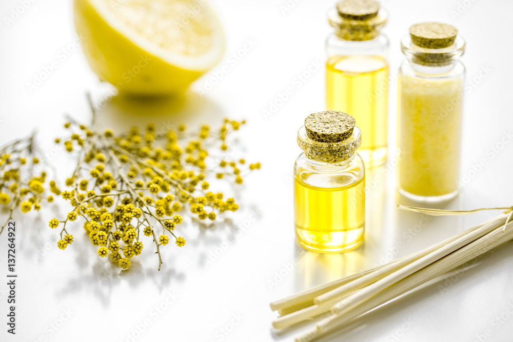 Home cosmetic with essential oil and sea salt on white background