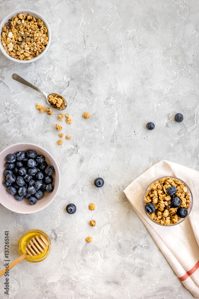 Oat flakes with honey and berries on table background top view