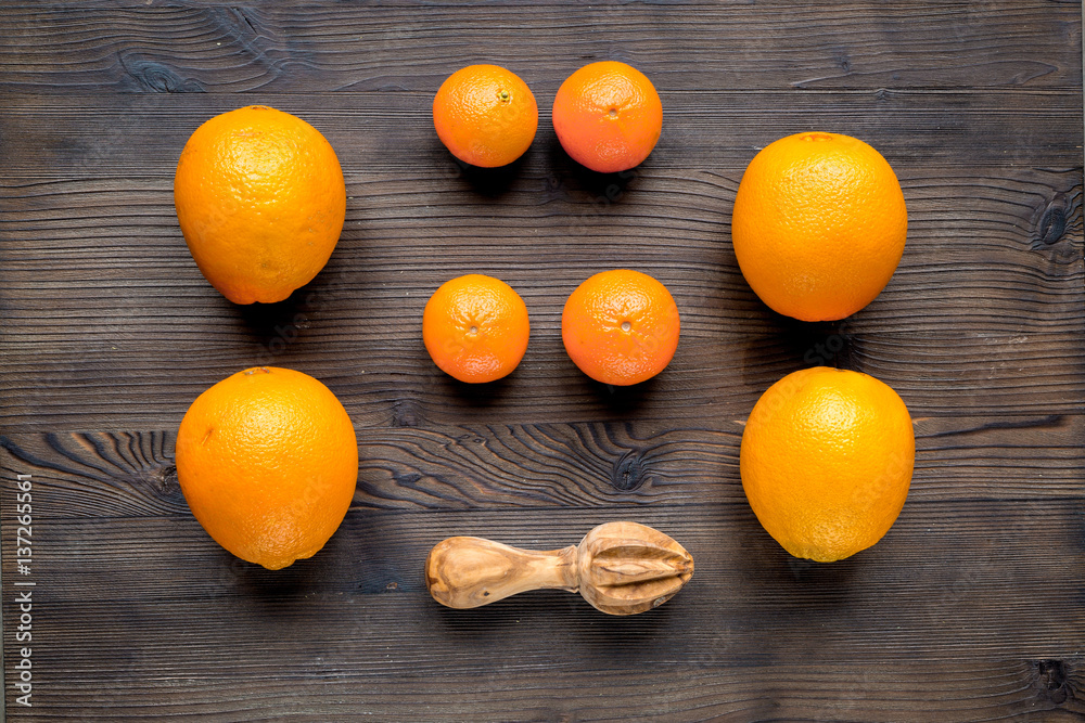 fresh oranges for juice on wooden background top view