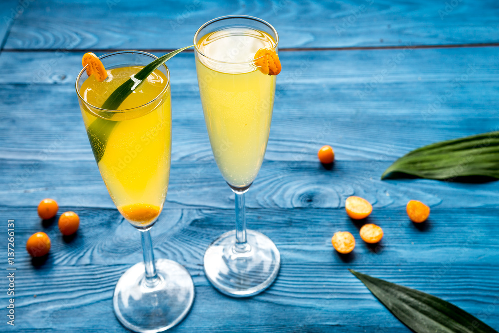 cocktail with physalis in glass on wooden background