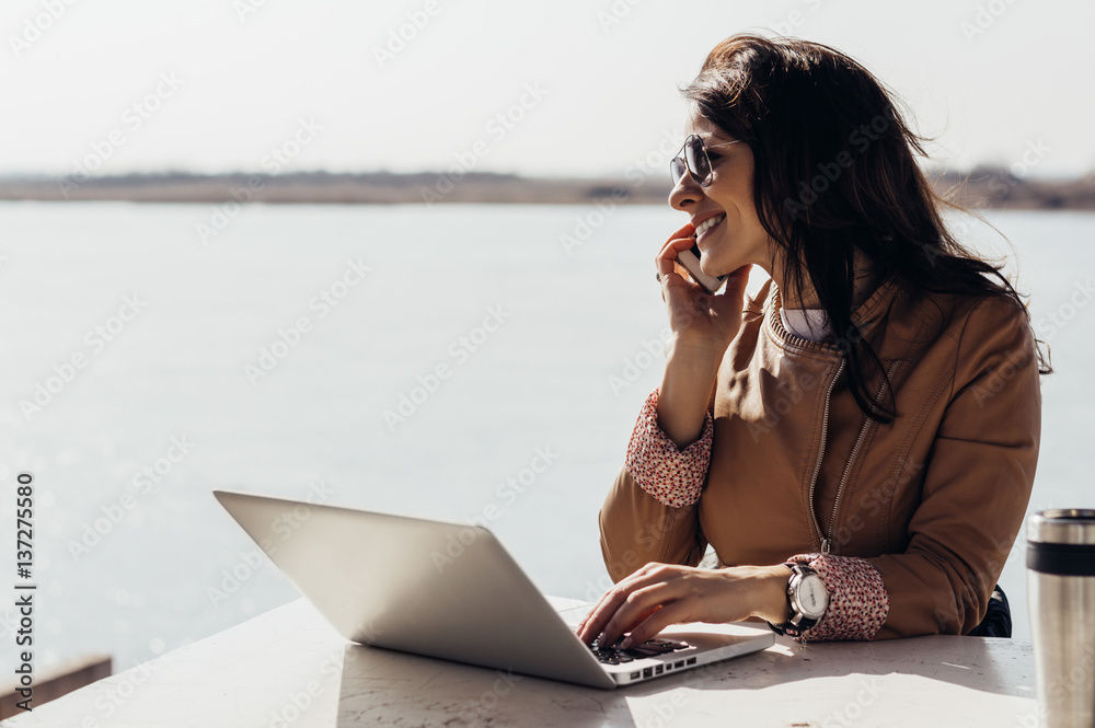 Charming woman working outside, talking with client