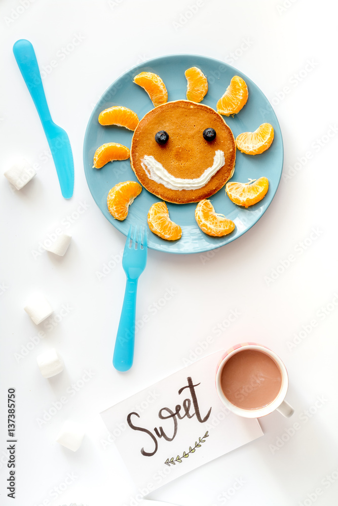 concept kid breakfast with pancake top view on white background