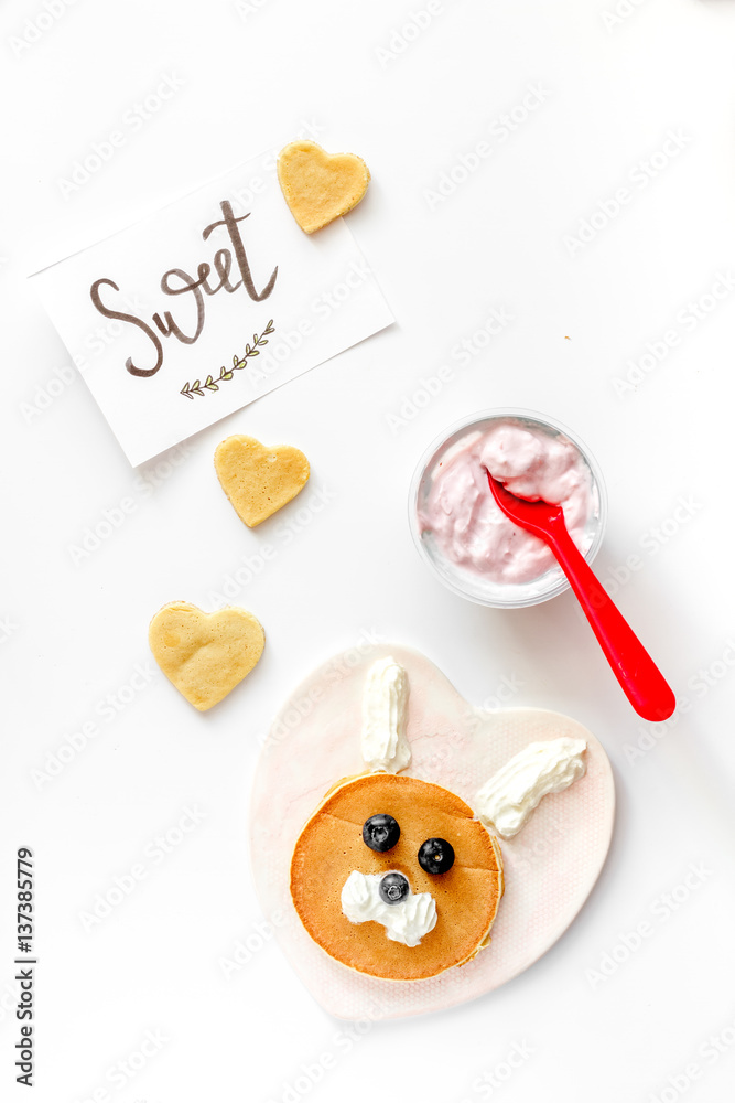 concept kid breakfast with pancake top view on white background